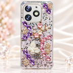 Fancy glitter phone case with purple and pink gem-style accents, floral details and raised butterfly decoration