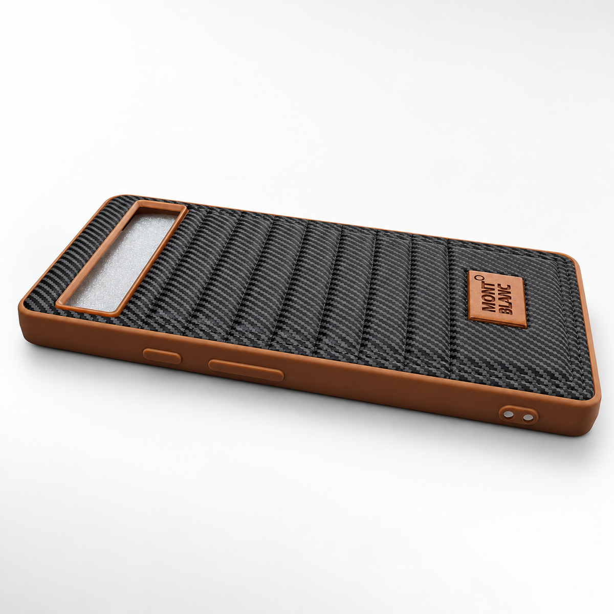 A protective phone case with a brown silicone frame and a textured black carbon-fiber-look backplate, featuring a small brown leather brand patch that reads 'MONT BLANC'.