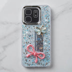 Glitter back phone case showing raised butterfly, bow and pearl-style decorations
