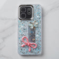 Fancy glitter phone case with raised butterfly, pink bow and pearl-style details