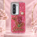 Close-up detail of glitter butterfly phone case with raised decorative charms