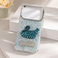 iPhone 17 Pro clear glitter case with teal rhinestone-style swan design