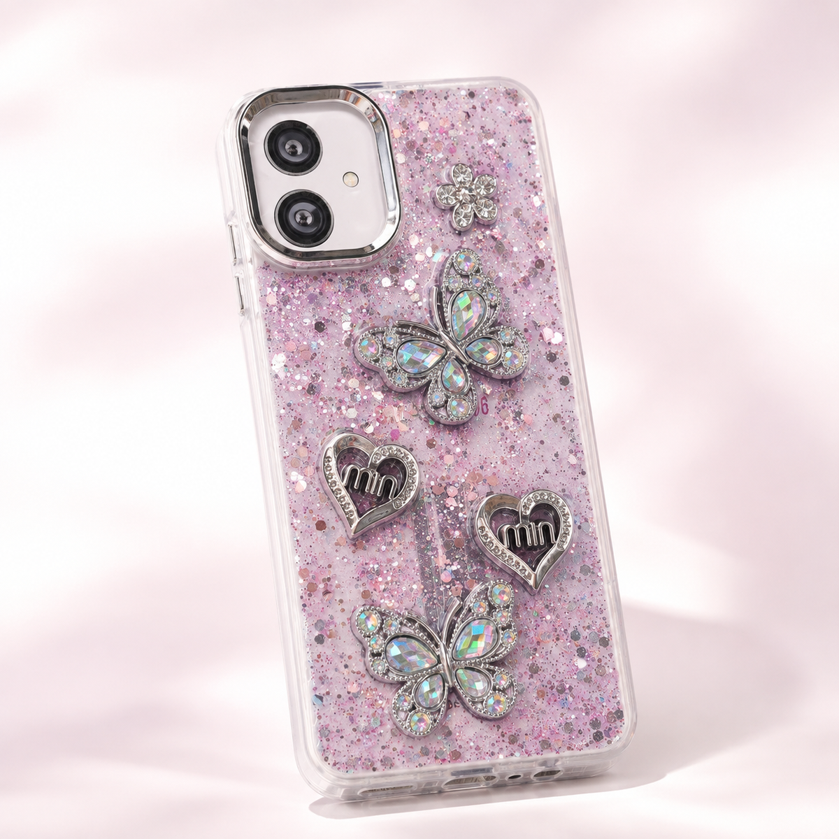 Samsung Galaxy A06 glitter butterfly and heart back cover showing raised decorations and camera surround