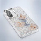 Angled view of white glitter butterfly pearl-bow phone case showing side frame and camera area