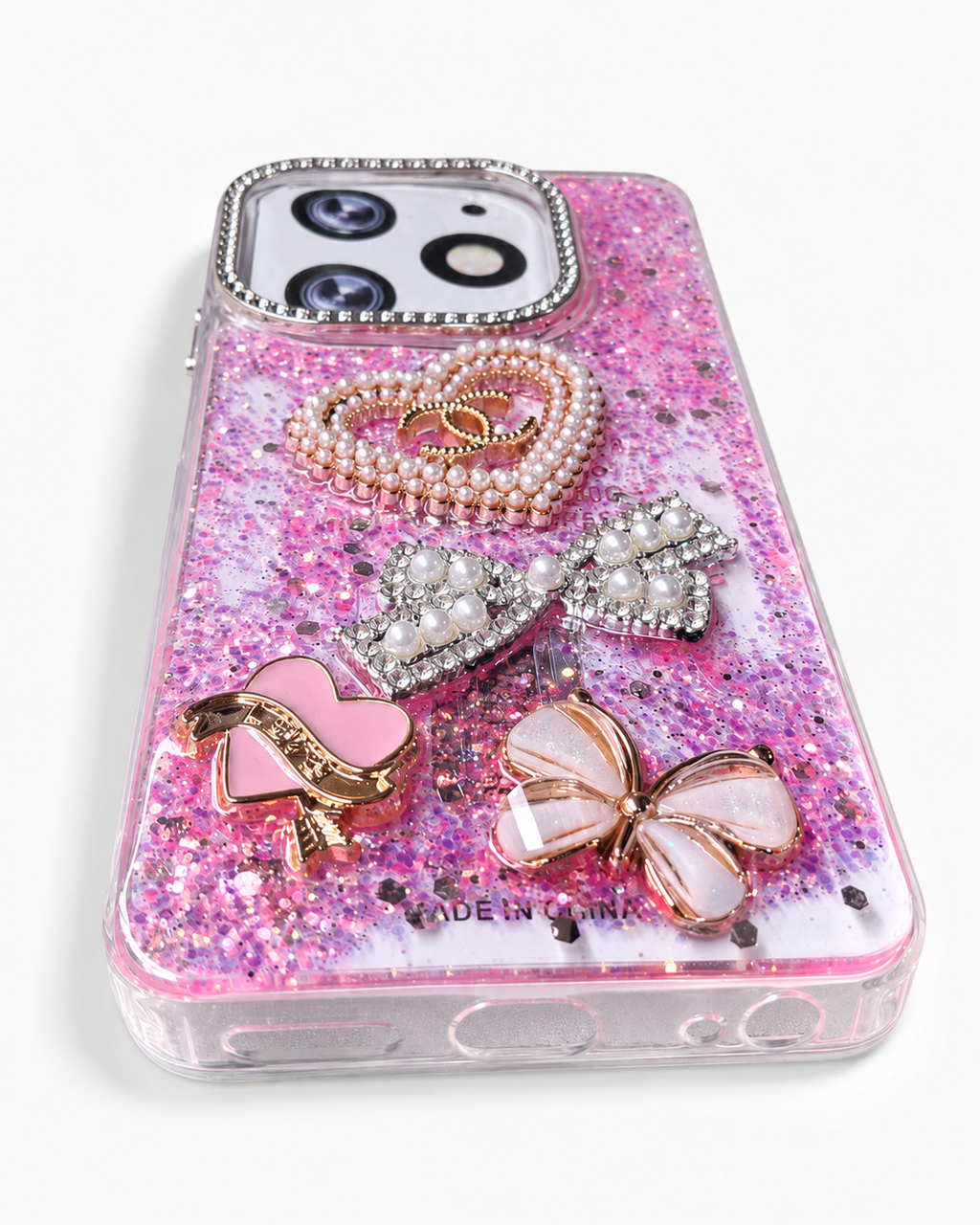 Pink glitter phone case angled view showing soft TPU sides and bottom cut-outs